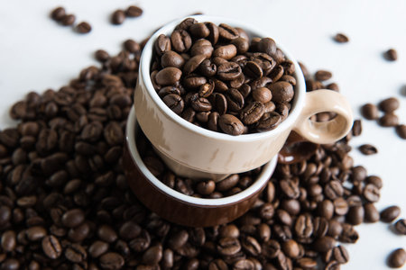 Two cups with coffee seeds.の写真素材