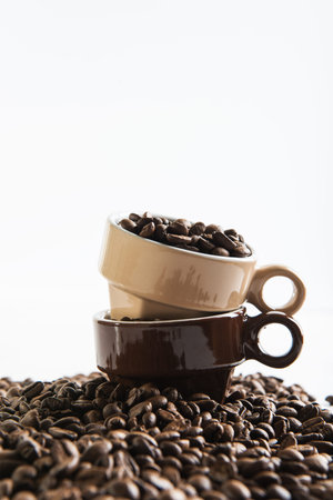 Two cups with coffee seeds.