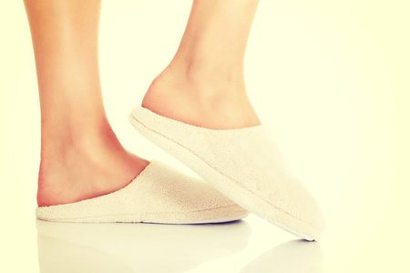 Female's feet with white slippers.の写真素材