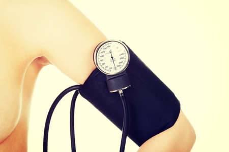 Female hand with blood-pressure meter isolated over whiteの写真素材