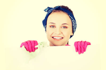 Smiling happy cleaning woman showing blank sign boardの写真素材