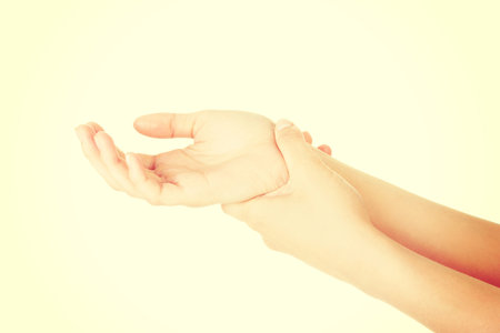Woman holding her hand - pain concept . Isolated on white