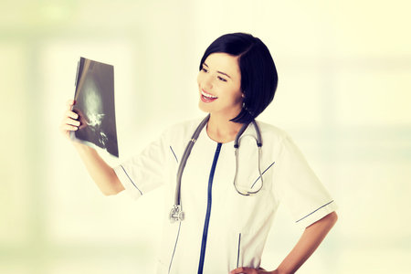 Female doctor or nurse looking at radiography photo