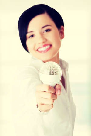 Businesswoman showing eco led bulb, isolated on whiteの写真素材