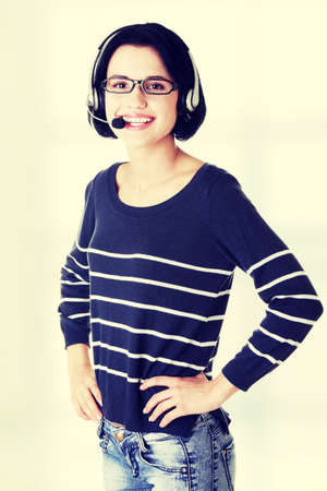 Closeup of attractive customer support representative smiling with headsetの写真素材