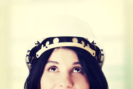 Portrait of confident female worker in helmet looking up. Isolated on whiteの写真素材