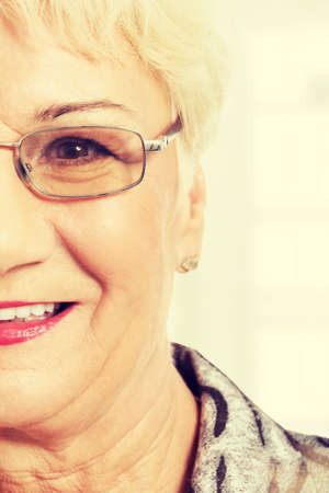 Portrait of an old woman, cut out. Isolated on white.の写真素材