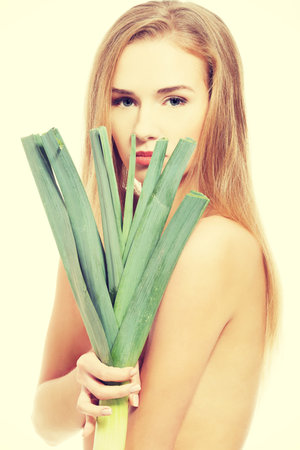 Beautiful caucasian woman with fresh green lettuce. Isolated on white.の写真素材