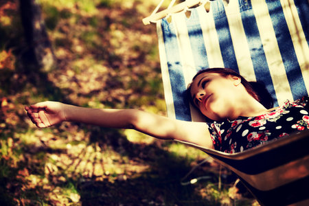 Young woman lying in hammock.