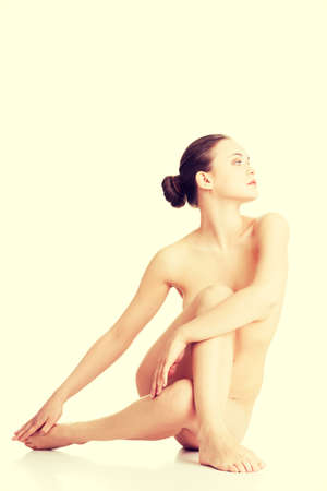 Sexy fit naked woman with healthy clean skin, isolated on white backgroundの写真素材