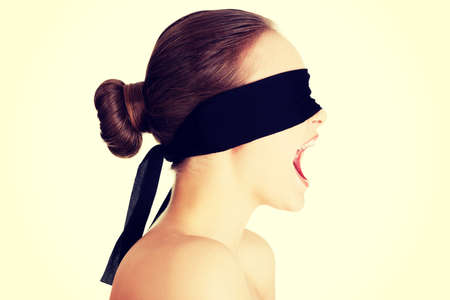 Blindfold woman screaming, isolated on white backgroundの写真素材