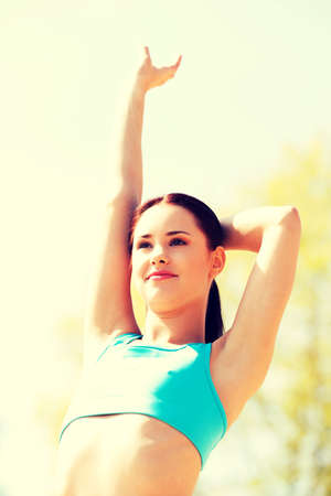 Young woman working out outdoorsの写真素材