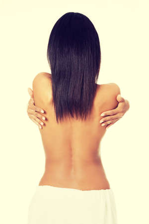 Young beautiful nude woman after bath or spa with towel , isolated on whiteの写真素材