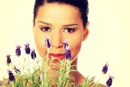 Beautiful girl smell purple lavender flowersの写真素材