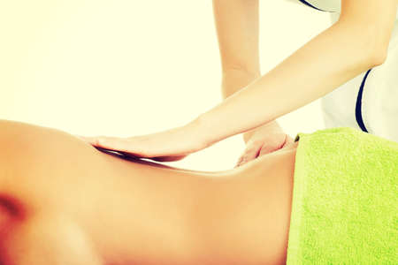 Woman relaxing in spa saloon - beeing massagedの写真素材