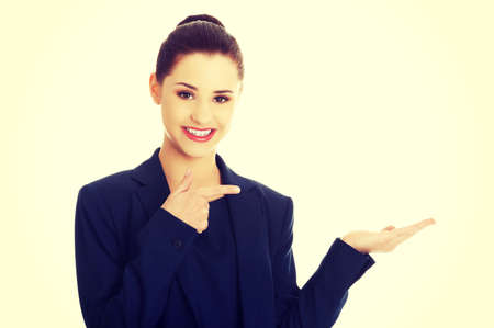 Business woman showing something or copyspase for product or sign textの写真素材