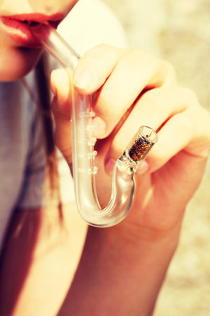 Teen Girl smoking cannabis outdoor.