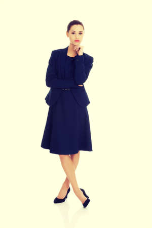 Thinking businesswoman standing pensive contemplating.の写真素材