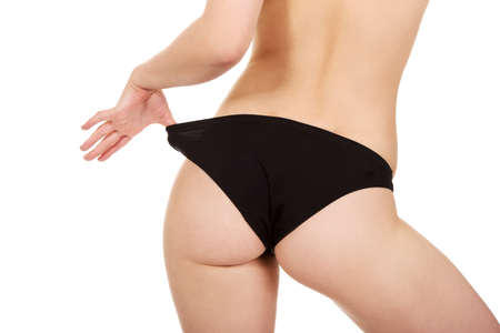 Sexy young woman back in panties.の写真素材