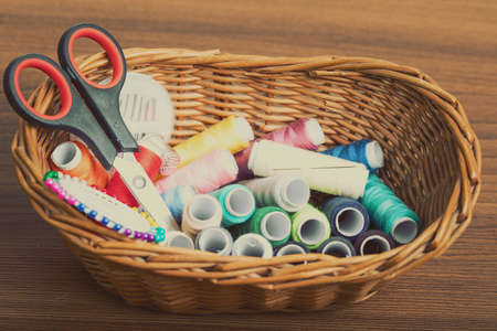 Sewing tools in willow basket.の写真素材