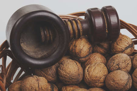 Walnuts in a willow basket with nutcracker.の写真素材