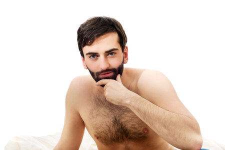 Young handsome man sitting on the bed.の写真素材