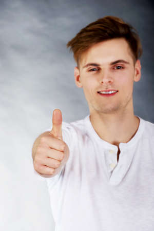 Young handsome man showing ok sign.の写真素材
