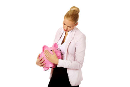 Young business woman holding piggybank.の写真素材