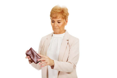 Worried elderly woman with empty wallet.の写真素材
