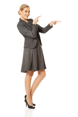Business woman pointing at copyspace on the left.の写真素材
