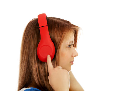 Teenage woman with red headphones.の写真素材