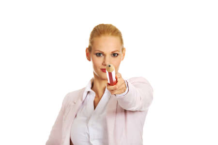 Attractive business woman pointing on camera with oversized pen.の写真素材