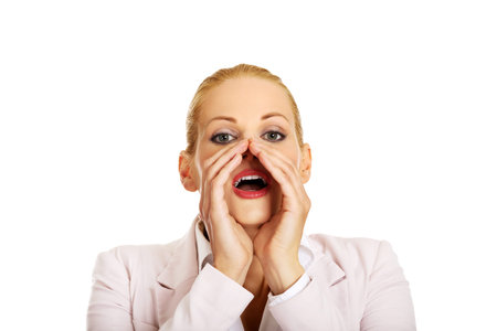 Young smiling business woman screaming loud or calling someone.の写真素材