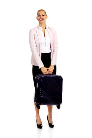 Smile business woman raising her suitcase.の写真素材