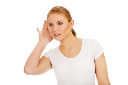 Shocked young woman overhears conversation.