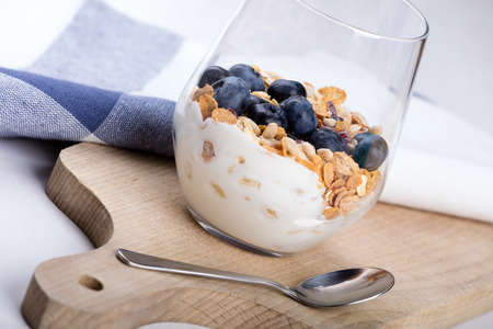 Dietetic breakfast - yoghurt with muesli and huckleberries.の写真素材