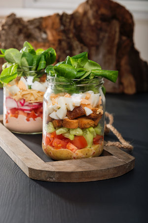 Two glass jars with fresh salad.の写真素材