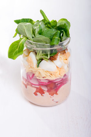 Glass jar with fresh salad.の写真素材