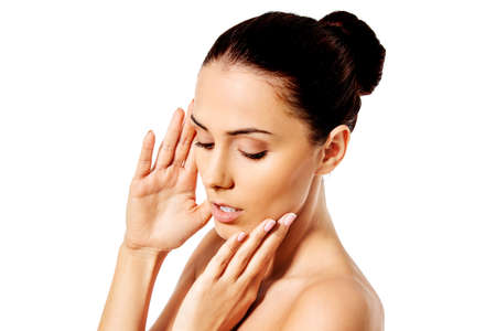 Beautiful face of young woman with clean fresh skin close up isolated on white.の写真素材