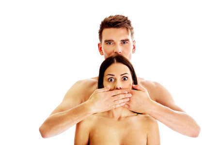 Man covering his girlfriends mouth, isolatedの写真素材