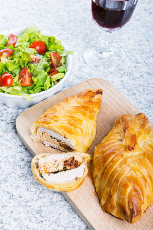 Chicken breast in french pastry with fresh salad.の写真素材