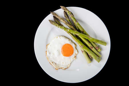 Green asparagus with fried egg.の写真素材