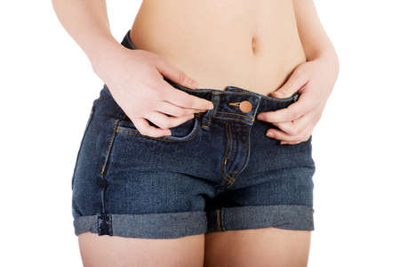 Beautiful slim woman wearing jeans showing belly.の写真素材