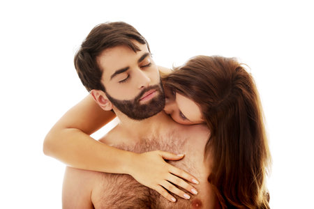 Beautiful woman kissing man's neck with desire.