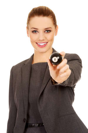 Happy business woman holding eight billiard ball.の写真素材