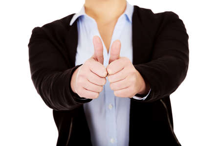 Young business woman shows thumbs up.の写真素材