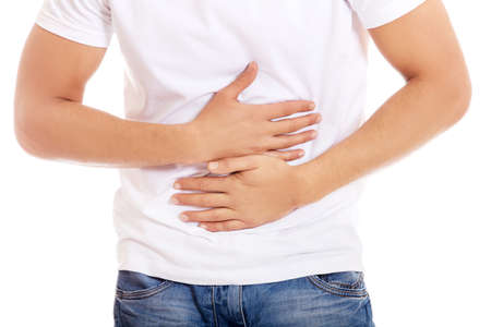 Young man with strong stomachache.の写真素材