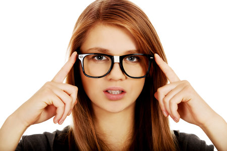 Pretty teenage woman improving glasses.