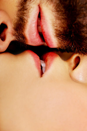 Happy young beautiful couple kissing.の写真素材