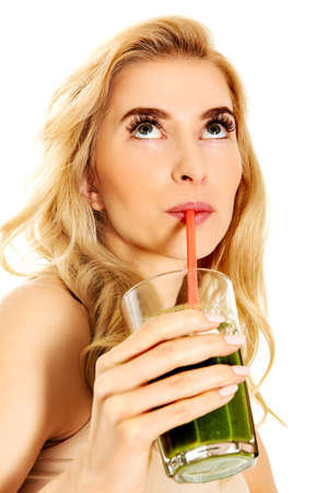 Young woman drinking green cocktail.の写真素材